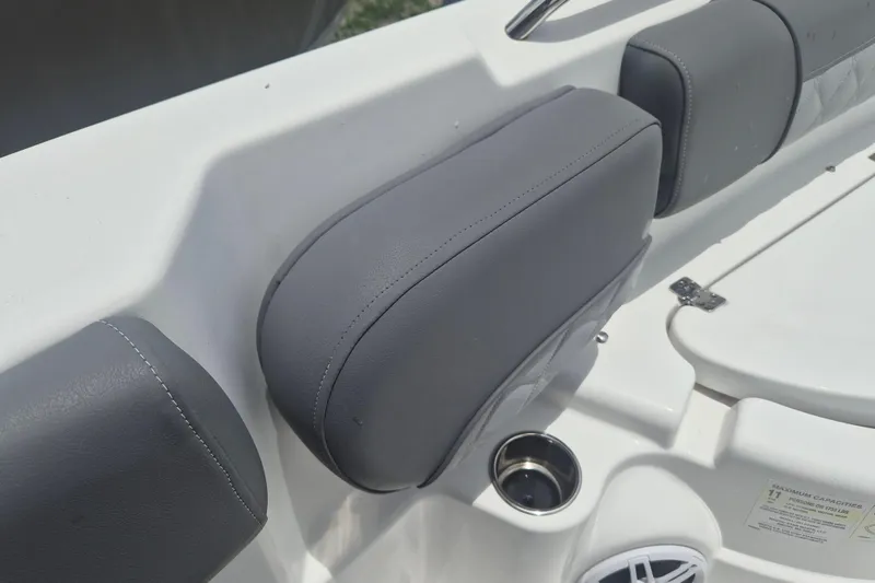 Slide: The Image of 2024 NauticStar 251 Hybrid boat interior with gray cushioned seating and cup holder. - 37