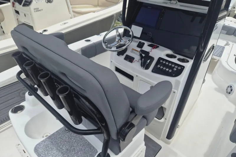 Slide: The Image of 2024 NauticStar 251 Hybrid boat cockpit with steering wheel and control panel. - 38
