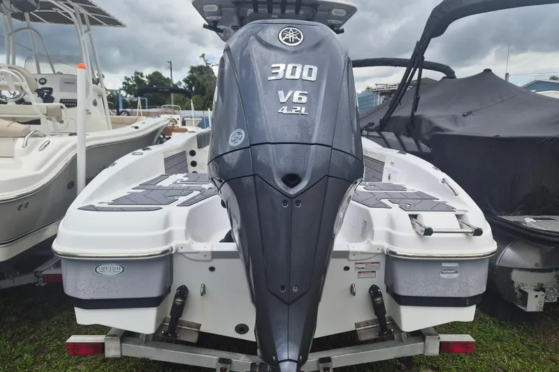 Slide: The Image of 2024 NauticStar 251 Hybrid boat with Yamaha 300 V6 engine, displayed outdoors. - 4