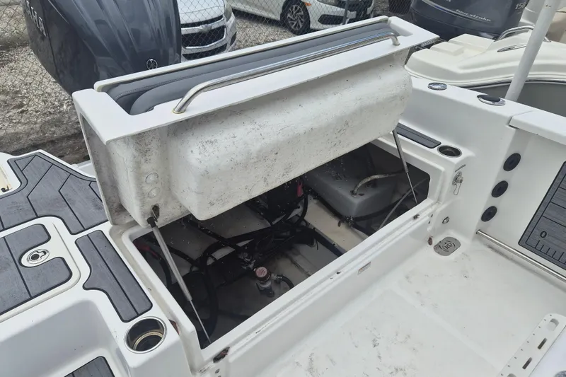 Slide: The Image of 2024 NauticStar 251 Hybrid boat storage compartment open, showcasing interior details. - 9