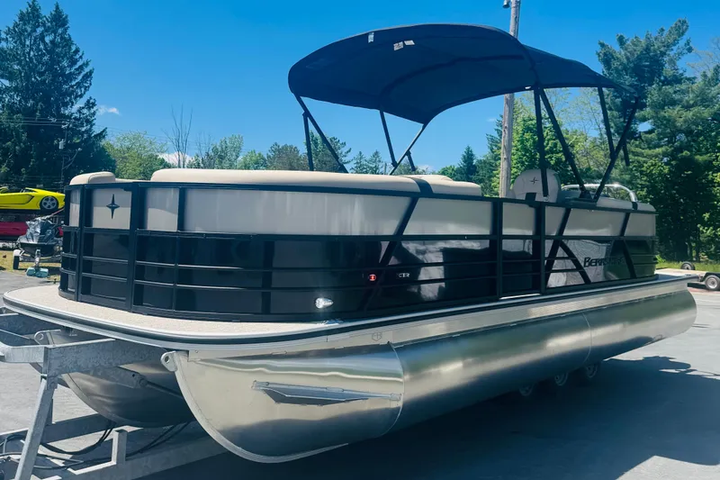The Image of 2026 Berkshire 24 RFX CTS pontoon boat with canopy on trailer, outdoors. - 0
