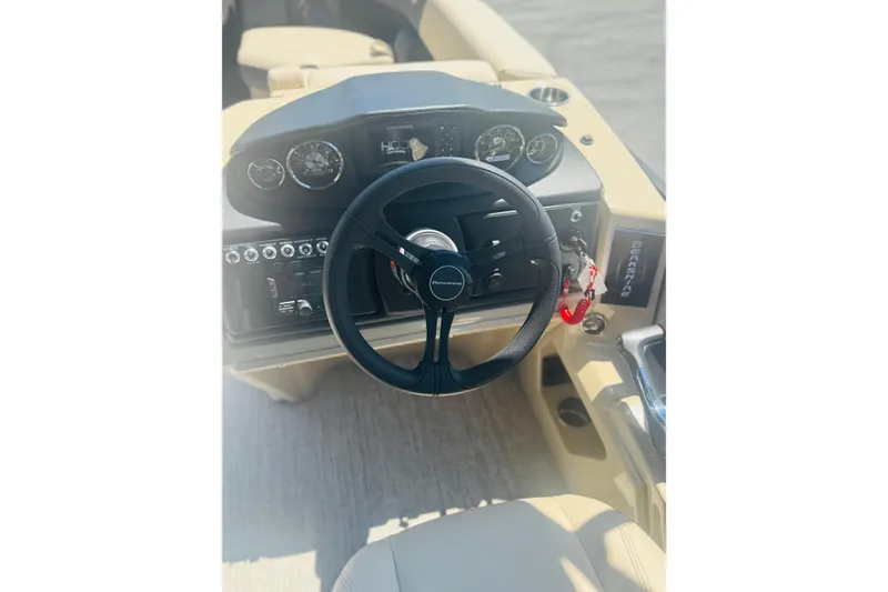 Slide: The Image of Steering console of 2026 Berkshire 24 RFX CTS boat with gauges and controls. - 12