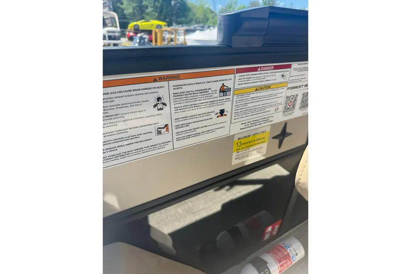 Slide: The Image of Warning labels on a 2026 Berkshire 24 RFX CTS boat, emphasizing safety instructions. - 13