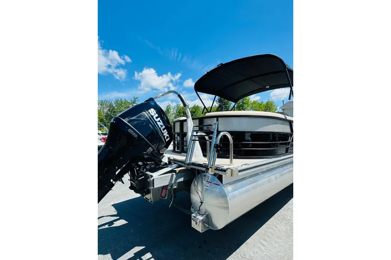 Slide: The Image of 2026 Berkshire 24 RFX CTS pontoon boat with Suzuki outboard motor under clear blue sky. - 3