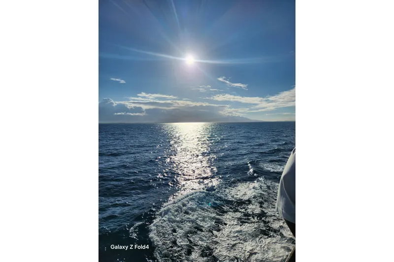 Slide: The Image of Sunset over ocean from 1990 Prowler Aft Cabin boat, captured on Galaxy Z Fold4. - 5