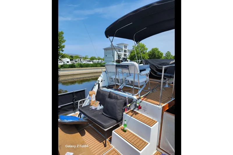Slide: The Image of 1990 Prowler Aft Cabin boat with seating and fishing rods on deck. - 6