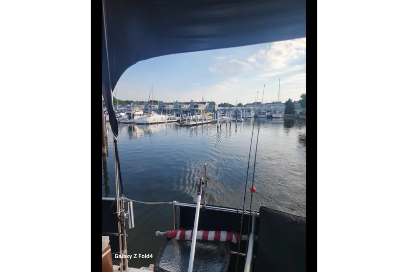 Slide: The Image of View from a 1990 Prowler Aft Cabin boat overlooking a marina with docked boats. - 7