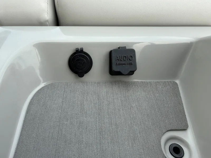Slide: The Image of Harris Sunliner 230 2021 audio and charging ports on gray carpet. - 17