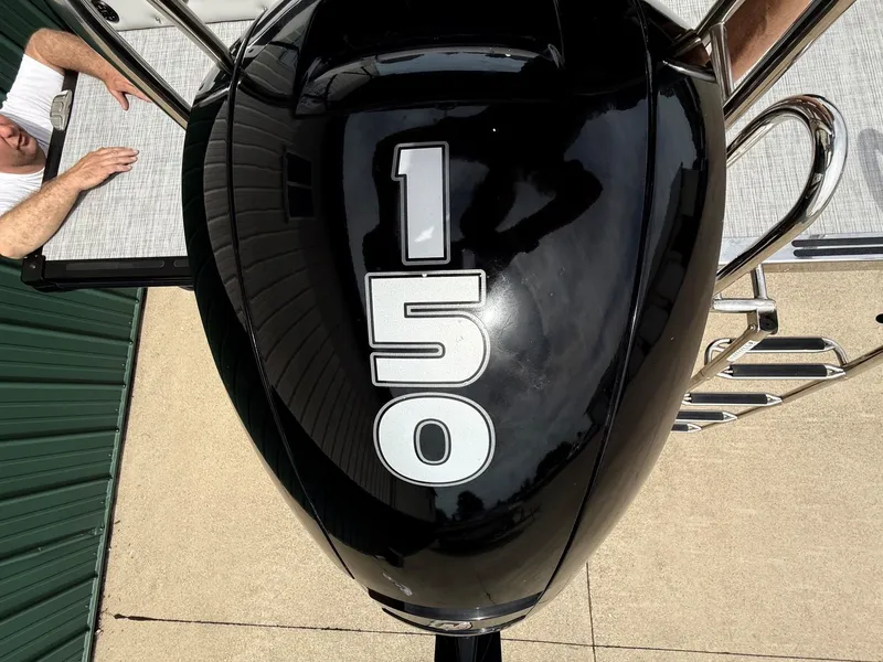 Slide: The Image of Black outboard motor with number 150 on a Harris Sunliner 230 boat. - 30