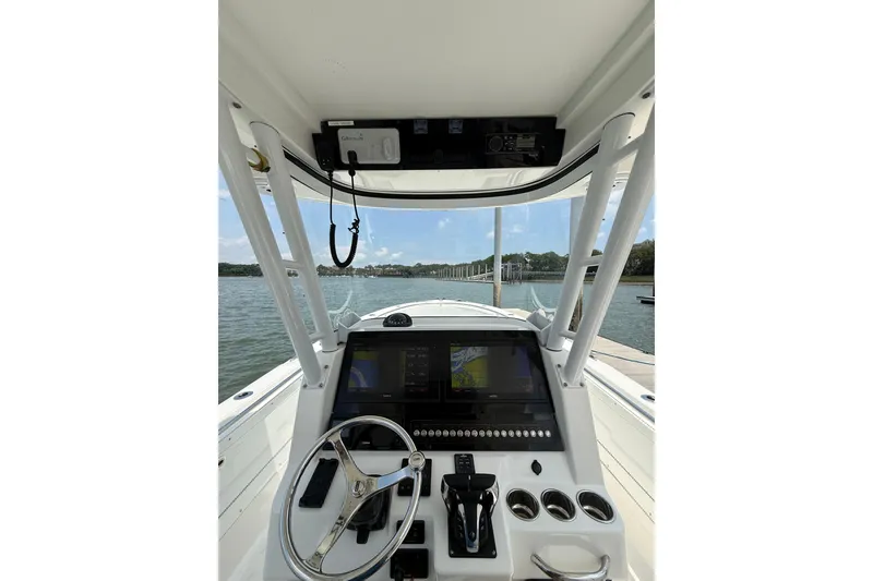 Slide: The Image of Cockpit view of 2018 Edgewater 320CC boat with navigation screens and steering wheel. - 10