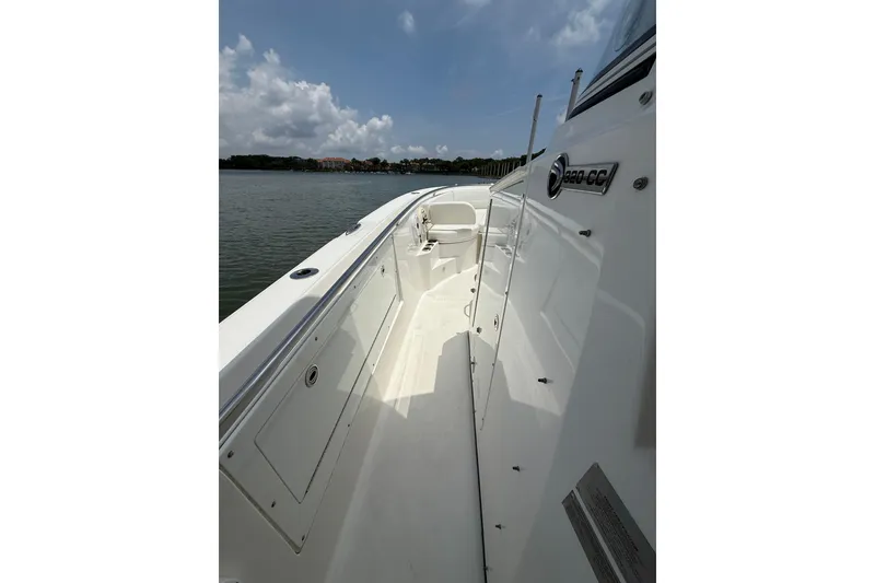 Slide: The Image of 2018 Edgewater 320CC boat deck with clear skies and calm waters. - 21