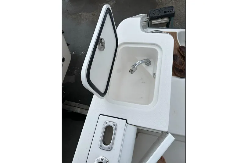 Slide: The Image of Edgewater 320CC 2018 boat sink with open lid. - 26