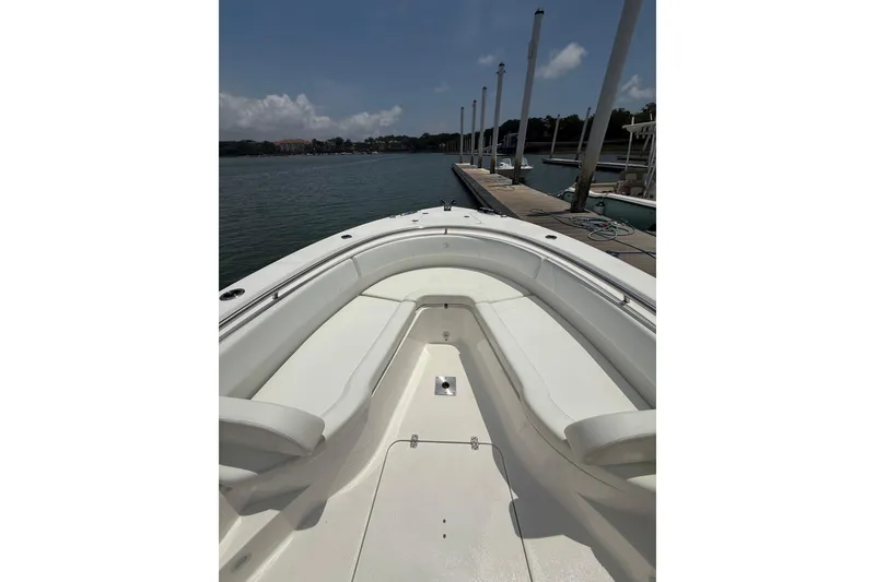 Slide: The Image of Bow view of 2018 Edgewater 320CC boat docked by the water. - 4