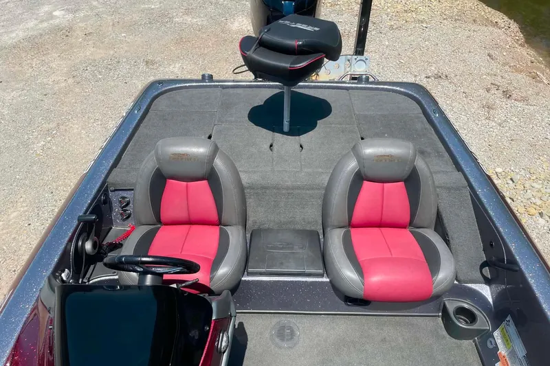 Slide: The Image of 2014 Skeeter ZX20 boat interior with red and gray seating on a sunny day. - 11