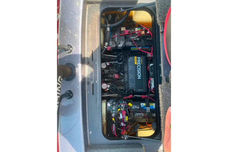 Slide: The Image of 2014 Skeeter ZX20 boat battery compartment with Precision charger and wiring. - 13