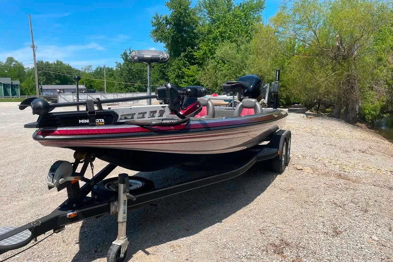 Slide: The Image of 2014 Skeeter ZX20 boat on trailer, parked near trees and water. - 7