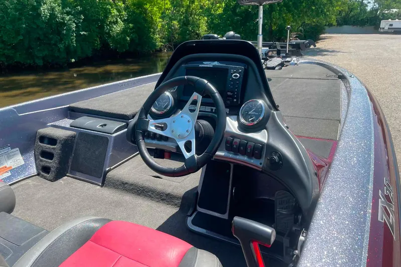 Slide: The Image of 2014 Skeeter ZX20 boat interior with steering wheel and dashboard controls. - 8