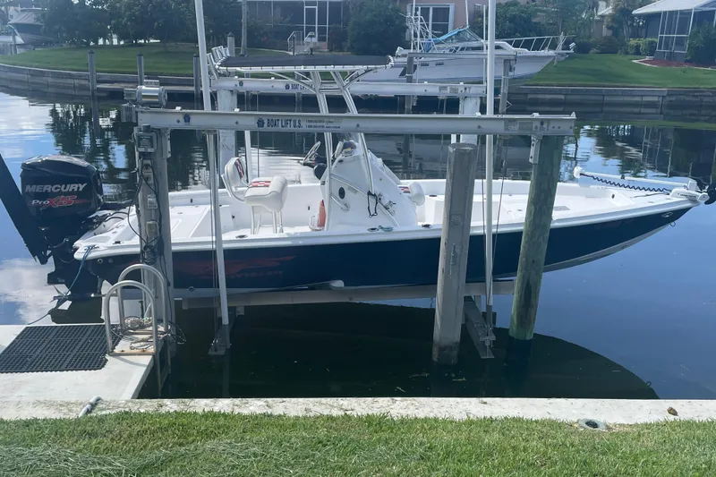 The Image of 2015 Glasstream 228 TE boat on lift, featuring Mercury Pro XS engine. - 1
