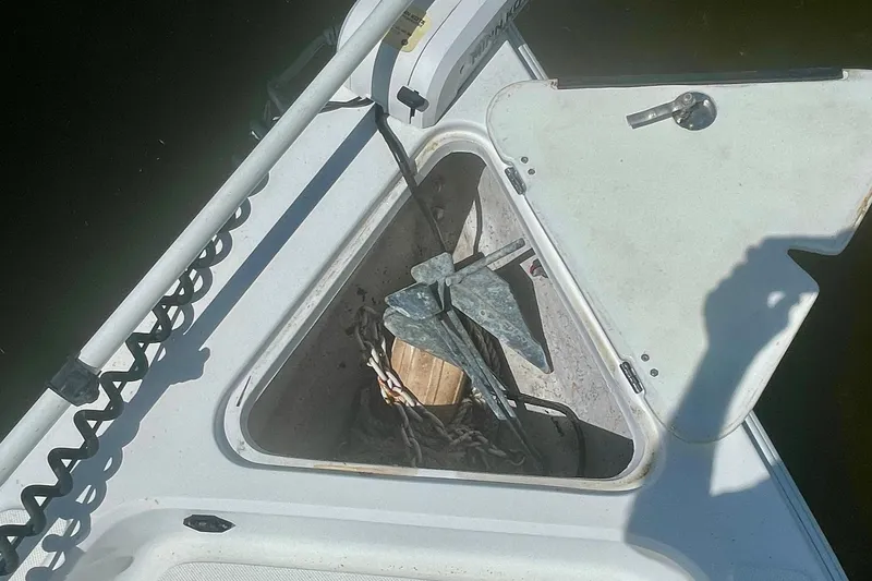 Slide: The Image of Open anchor compartment on 2015 Glasstream 228 TE boat, showing anchor and ropes. - 9