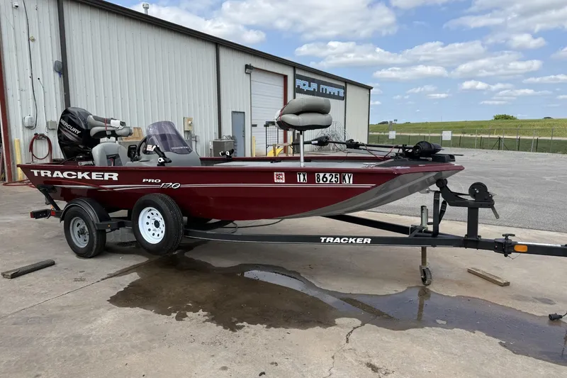 The Image of 2018 Tracker Pro 170 boat on trailer, parked outside a warehouse. - 1