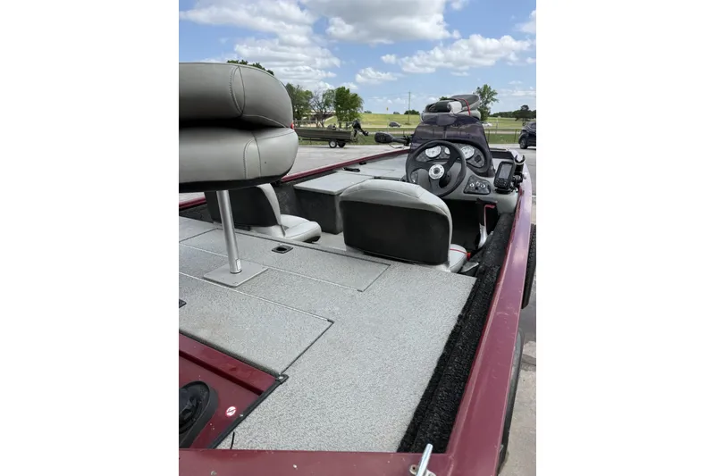 Slide: The Image of 2018 Tracker Pro 170 boat interior with steering console and seating under a clear sky. - 10