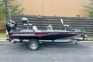 The Image of 2016 Tracker Pro Team 175 TXW fishing boat on trailer, parked outdoors. - 1
