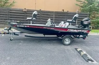 Slide: The Image of 2016 Tracker Pro Team 175 TXW boat on trailer, parked outdoors. - 13