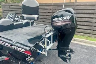 Slide: The Image of 2016 Tracker Pro Team 175 TXW boat with Mercury outboard motor, parked outdoors. - 14