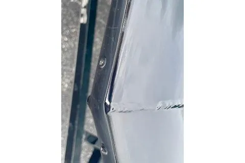 Slide: The Image of Close-up of 2016 Tracker Pro Team 175 TXW boat's metallic surface detail. - 17