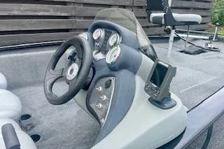 Slide: The Image of 2016 Tracker Pro Team 175 TXW boat dashboard with steering wheel and gauges. - 4