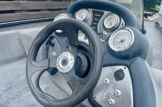 Slide: The Image of 2016 Tracker Pro Team 175 TXW boat dashboard with steering wheel and gauges. - 5