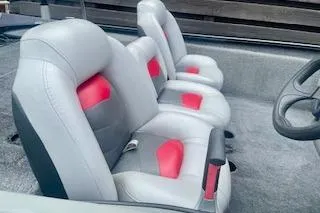 Slide: The Image of 2016 Tracker Pro Team 175 TXW boat interior with gray and red seating. - 6