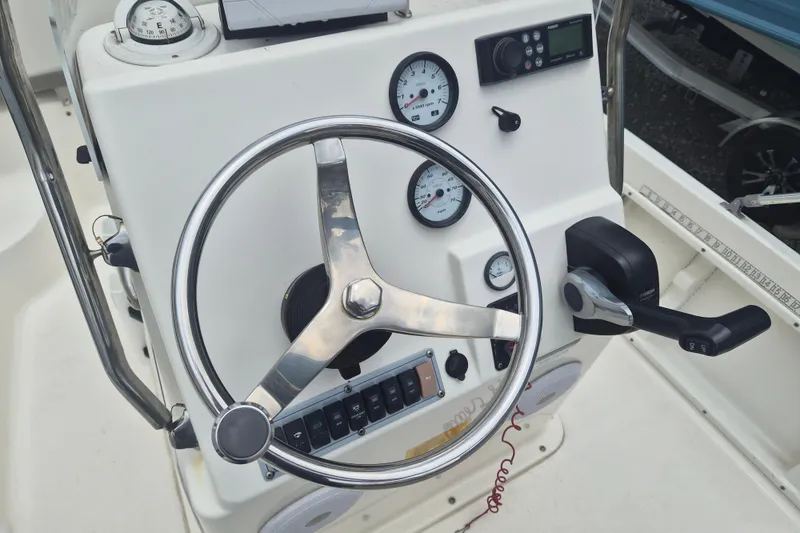 Slide: The Image of Steering console of a 2021 Key West 1720 Center Console boat with gauges and controls. - 12