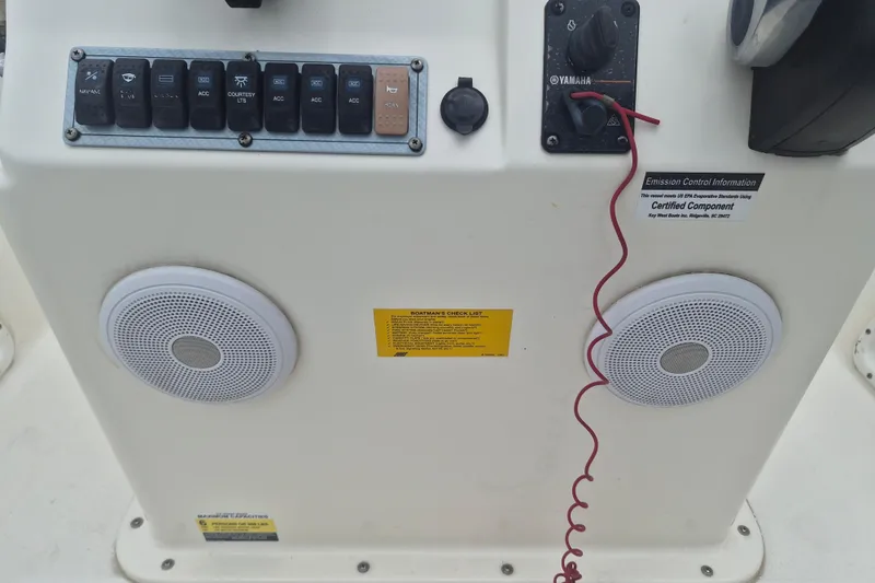 Slide: The Image of Control panel of a 2021 Key West 1720 Center Console boat with speakers and switches. - 13