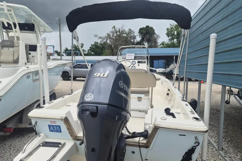 Slide: The Image of 2021 Key West 1720 Center Console boat with Yamaha 90 engine, parked outdoors. - 3