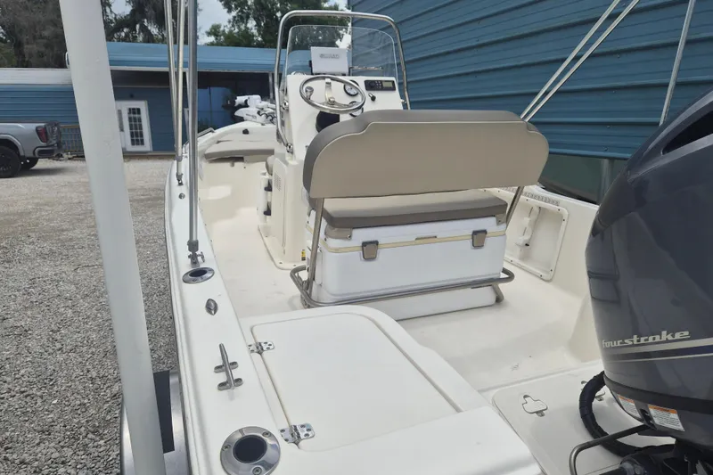 Slide: The Image of 2021 Key West 1720 Center Console boat with outboard motor, parked on gravel. - 4