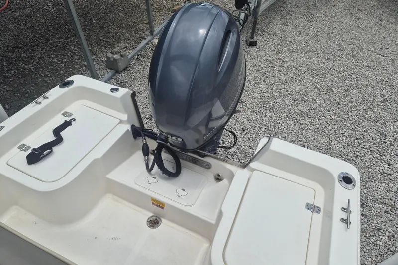 Slide: The Image of 2021 Key West 1720 Center Console boat with outboard motor on gravel surface. - 6