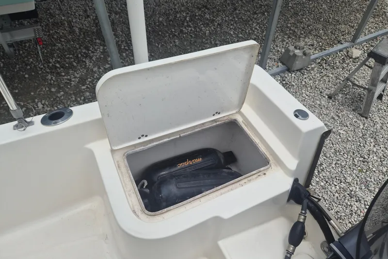 Slide: The Image of 2021 Key West 1720 Center Console boat storage compartment with equipment inside. - 7