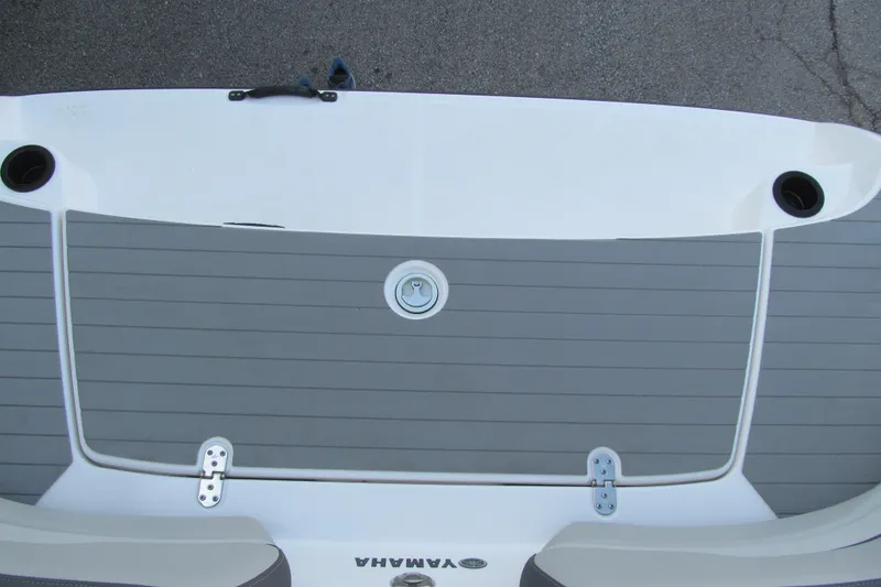Slide: The Image of 2024 Yamaha SX190 boat swim platform with gray decking and cup holders. - 14