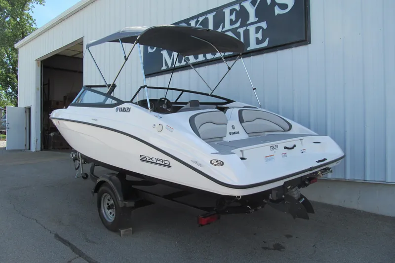 Slide: The Image of 2024 Yamaha Boats SX190 on trailer outside marine dealership. - 2