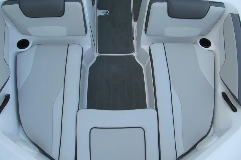 Slide: The Image of 2024 Yamaha Boats SX190 interior seating with gray upholstery and cup holders. - 9
