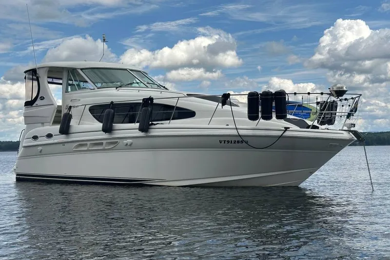 The Image of 2004 Sea Ray 390 Motor Yacht on calm water under a partly cloudy sky. - 0