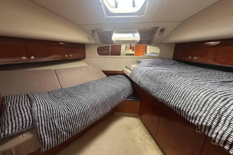 Slide: The Image of Interior cabin of 2004 Sea Ray 390 Motor Yacht with twin beds and wood cabinetry. - 10