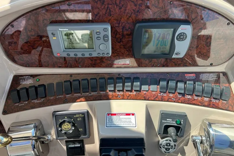 Slide: The Image of Control panel of a 2004 Sea Ray 390 Motor Yacht with navigation instruments. - 13