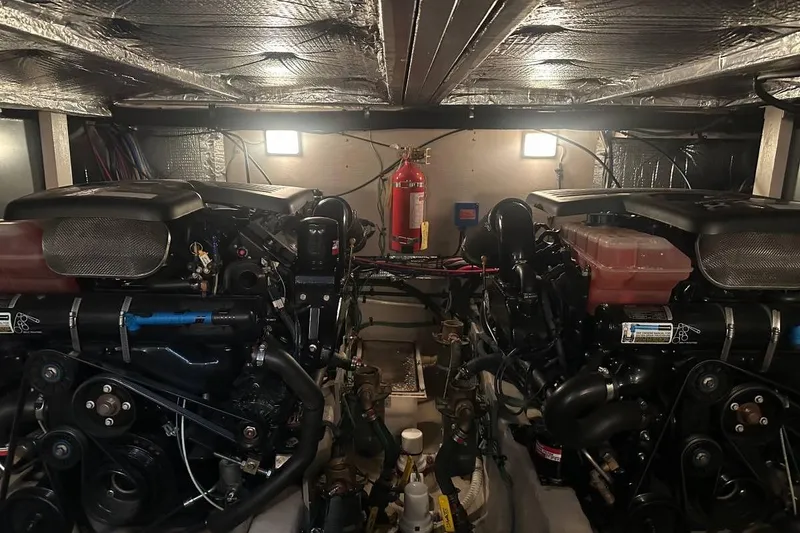 Slide: The Image of Engine room of a 2004 Sea Ray 390 Motor Yacht with dual engines and fire extinguisher. - 15