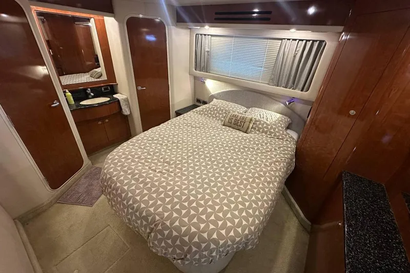 Slide: The Image of Luxurious bedroom interior of 2004 Sea Ray 390 Motor Yacht with cozy bedding. - 6