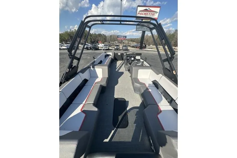 Slide: The Image of 2024 Manitou Cruise 22 Max Bench V-Toon boat interior with seating and steering console. - 7