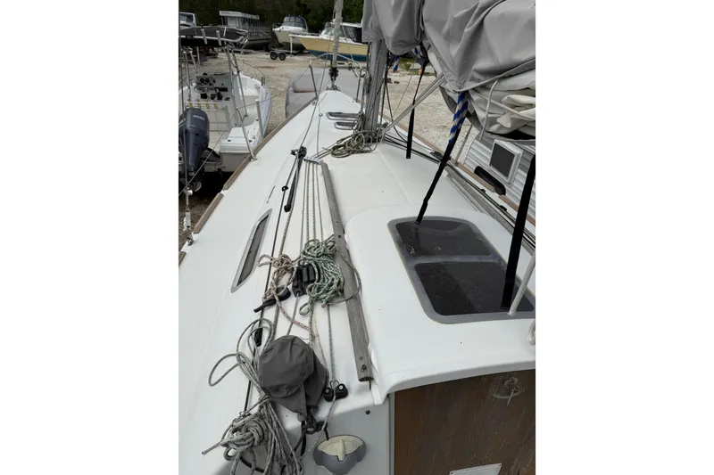 Slide: The Image of 2014 Beneteau FIRST 25 S sailboat deck with rigging and covered sails. - 12