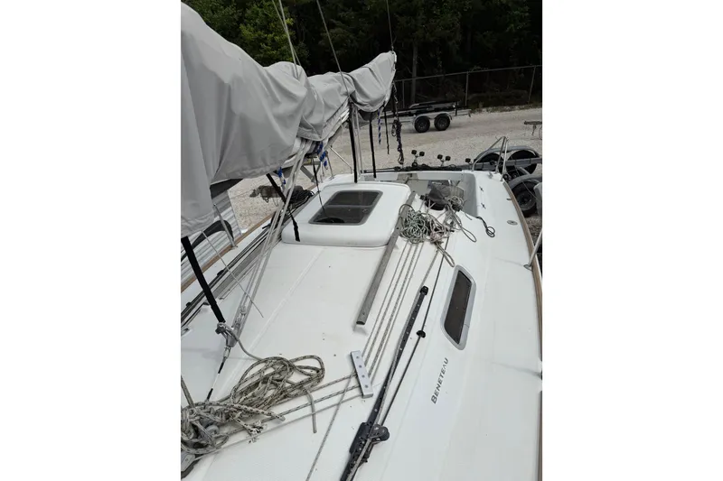 Slide: The Image of 2014 Beneteau FIRST 25 S sailboat deck with covered sails and rigging. - 15