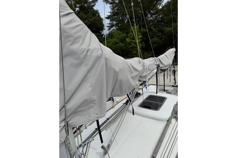 Slide: The Image of 2014 Beneteau FIRST 25 S sailboat deck with covered boom and rigging. - 16